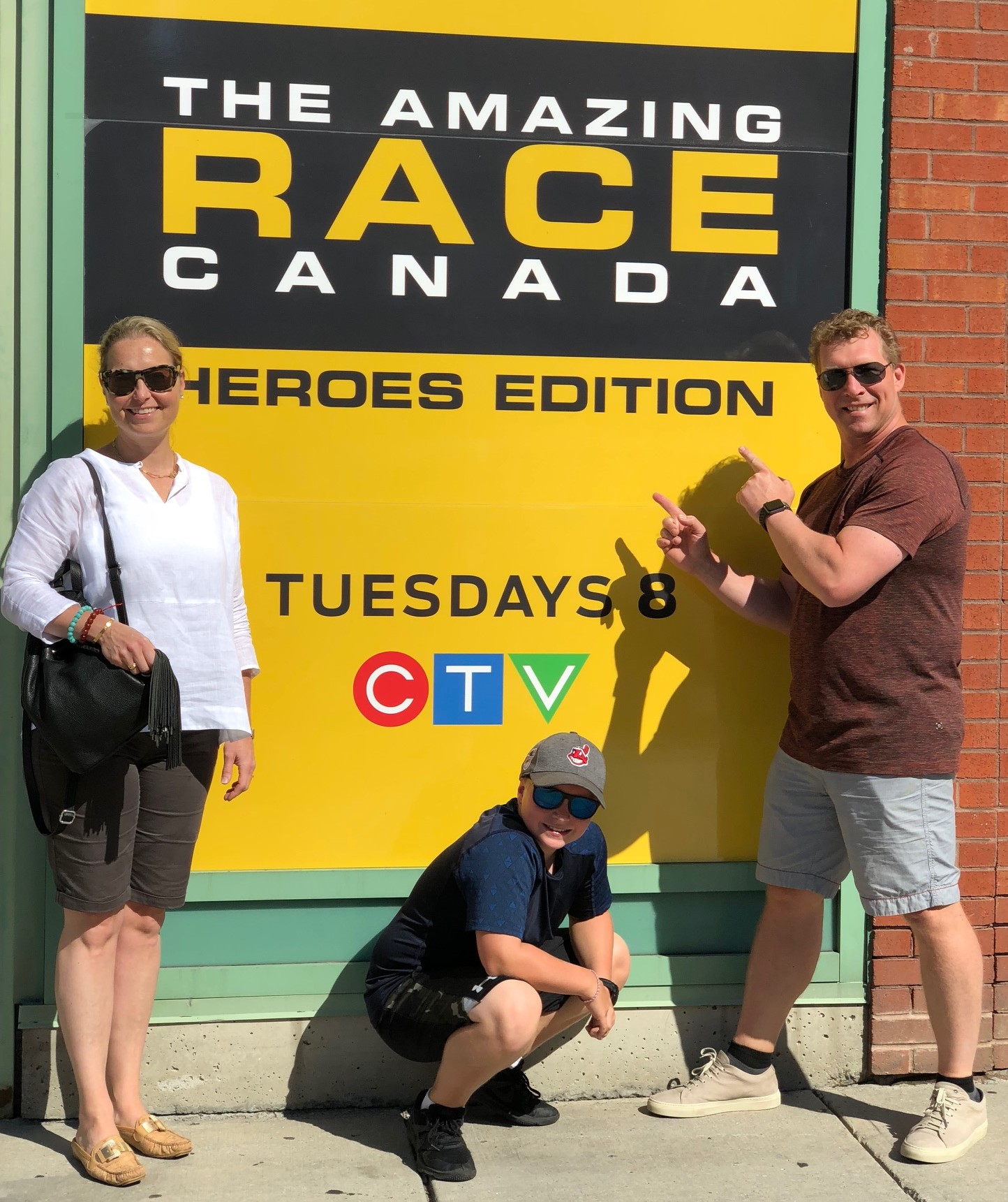 Posing with and Amazing Race Canada promotional sign